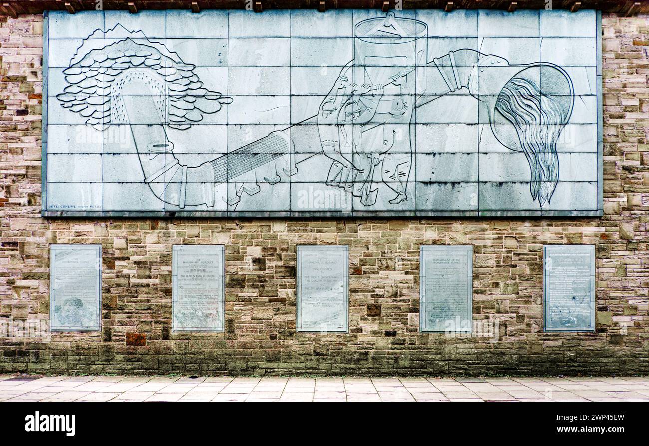 Sculptured relief panel, by Mitzi Cunliffe, on the Heaton Park pumping station, depicting the  Haweswater Aquaduct.  Prestwich,  Manchester, UK Stock Photo