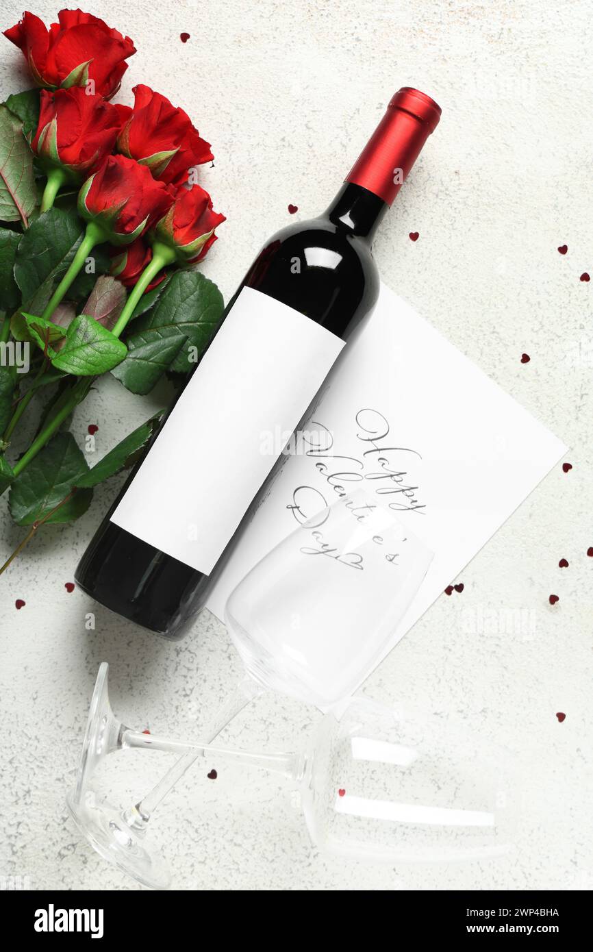 Card with text HAPPY VALENTINE'S DAY, bottle of wine, glasses and red ...