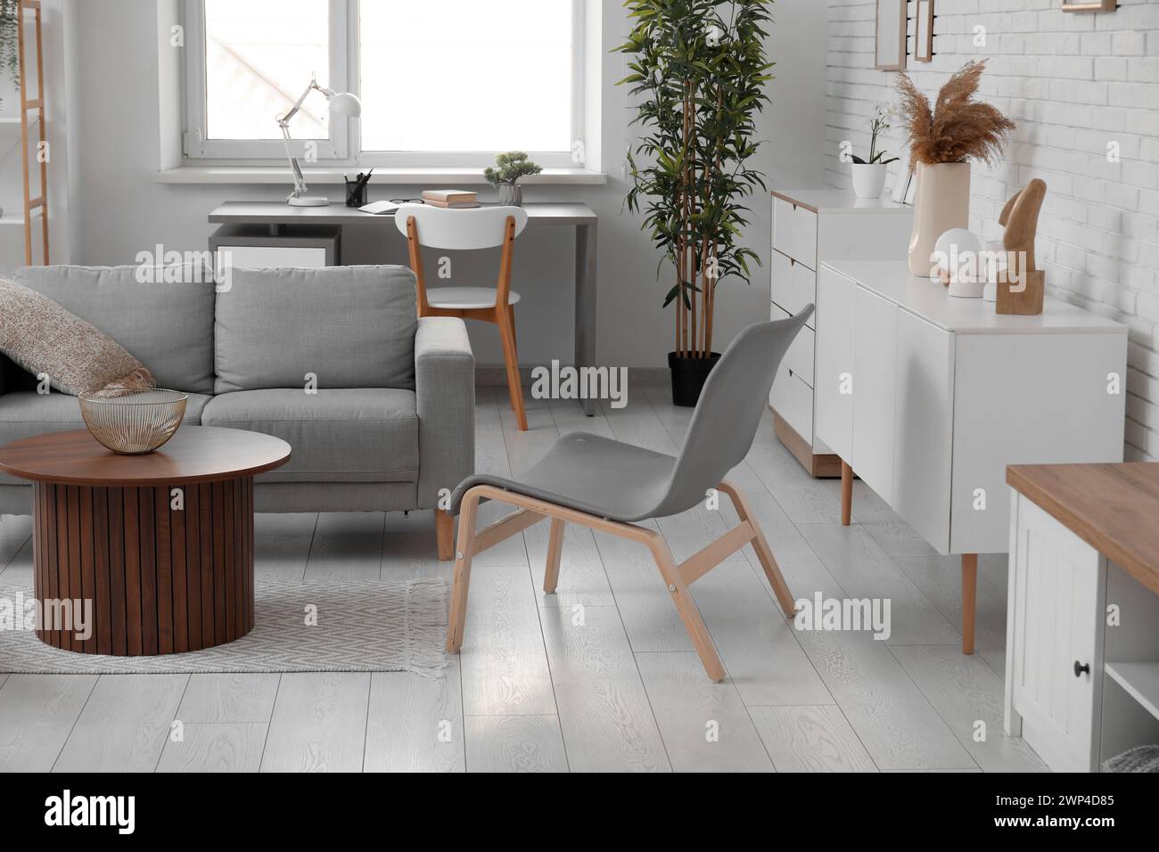 Stylish interior of living room with grey sofa and chairs Stock Photo ...