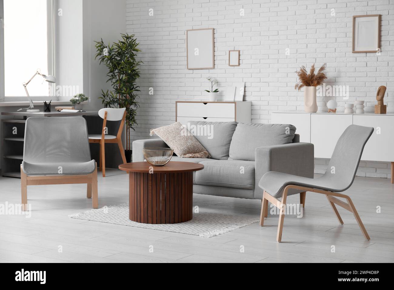 Stylish interior of living room with grey sofa and chairs Stock Photo ...