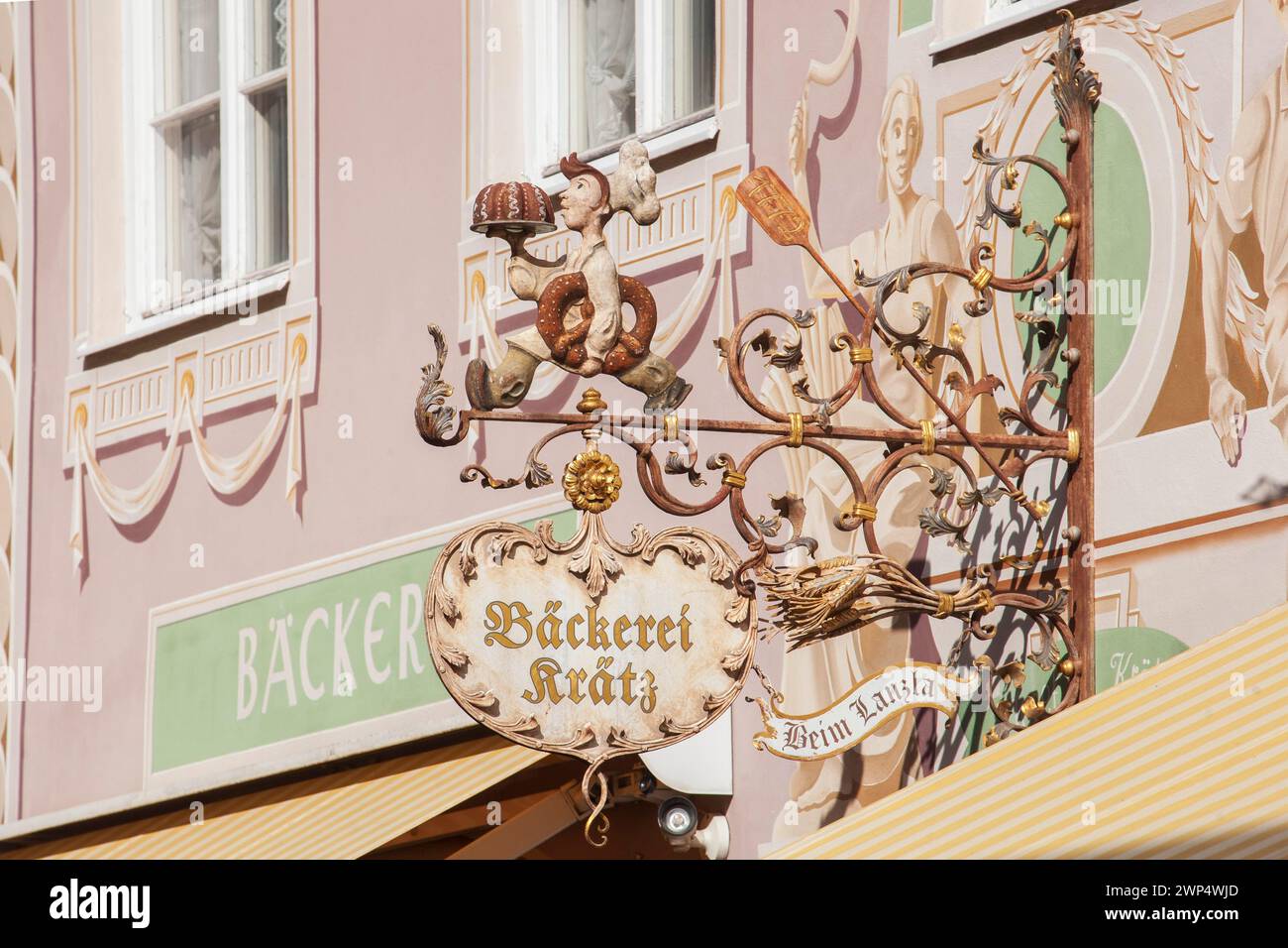 Old, decorated hanging sign of the Kraetz bakery in Ludwigstrasse ...