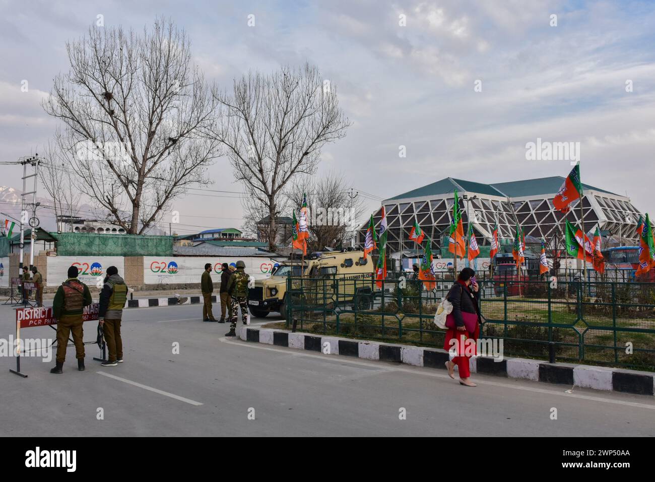 Srinagar, India. 05th Mar, 2024. A woman walks past government forces ...
