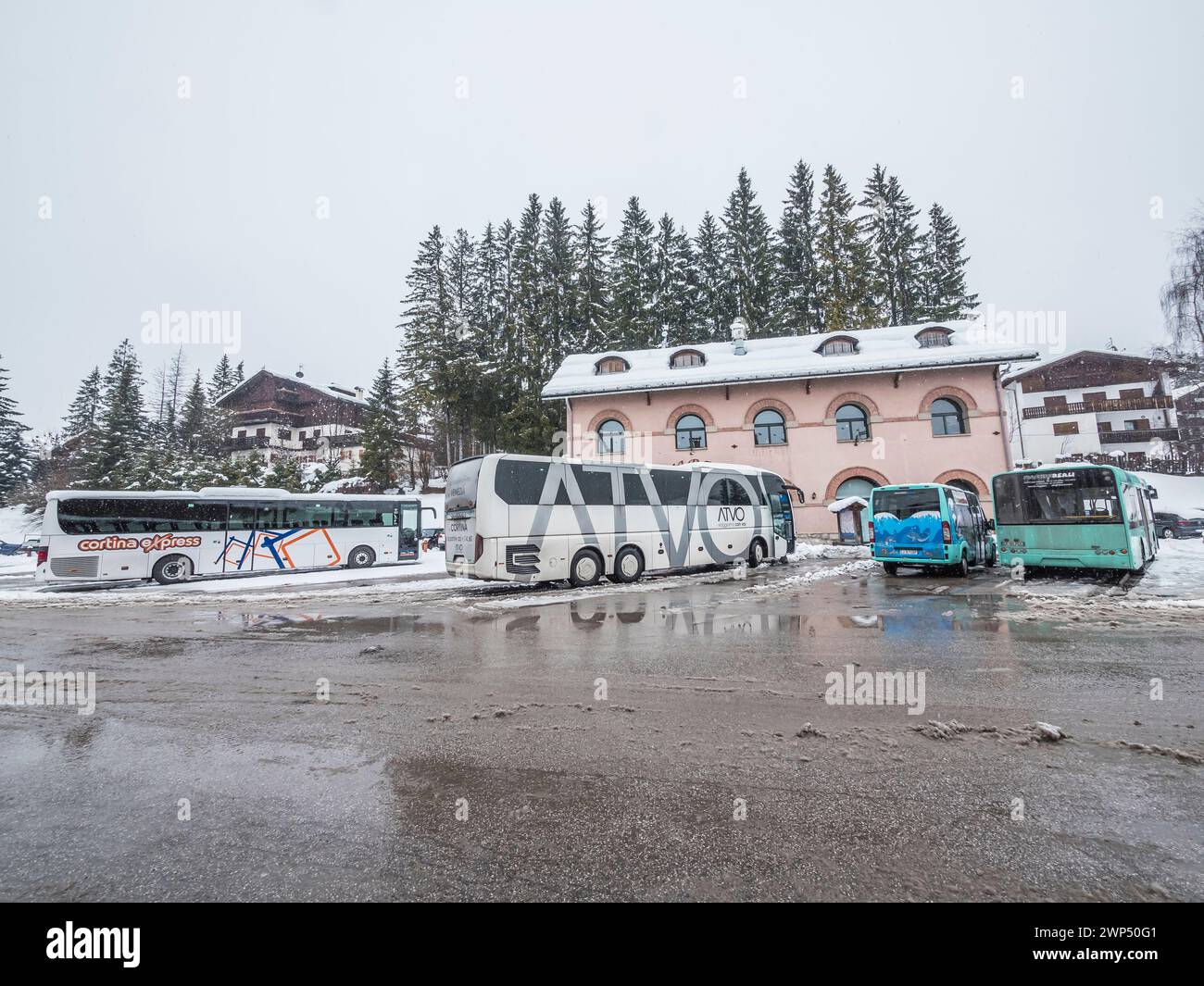 This unflattering winter street scene is of the bus station in the resort town of Cortina d'Ampezzo located in the mountains of the Italian Dolomites Stock Photo