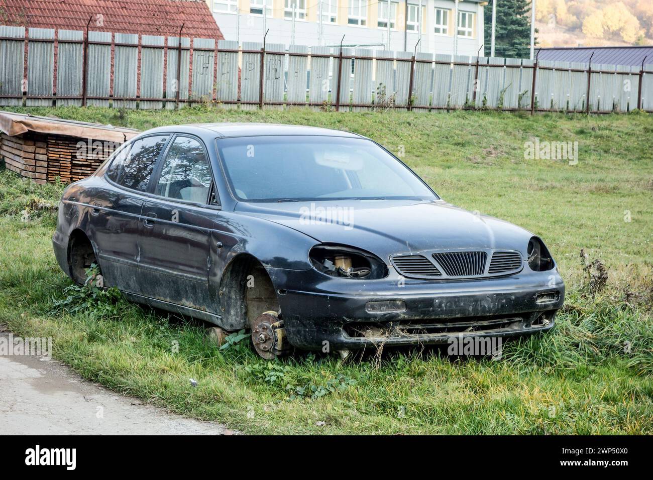 ZBOROV NAD BYSTRICOU - OCTOBER 30, 2015: Abandoned wreck of Daewoo Leganza sedan car without any wheels Stock Photo