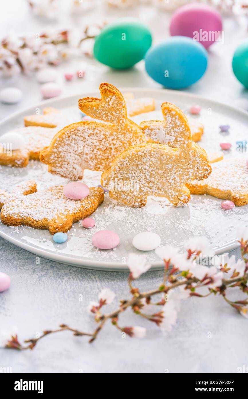 Homemade almond bunny cookies for Easter with colorful Easter eggs Stock Photo