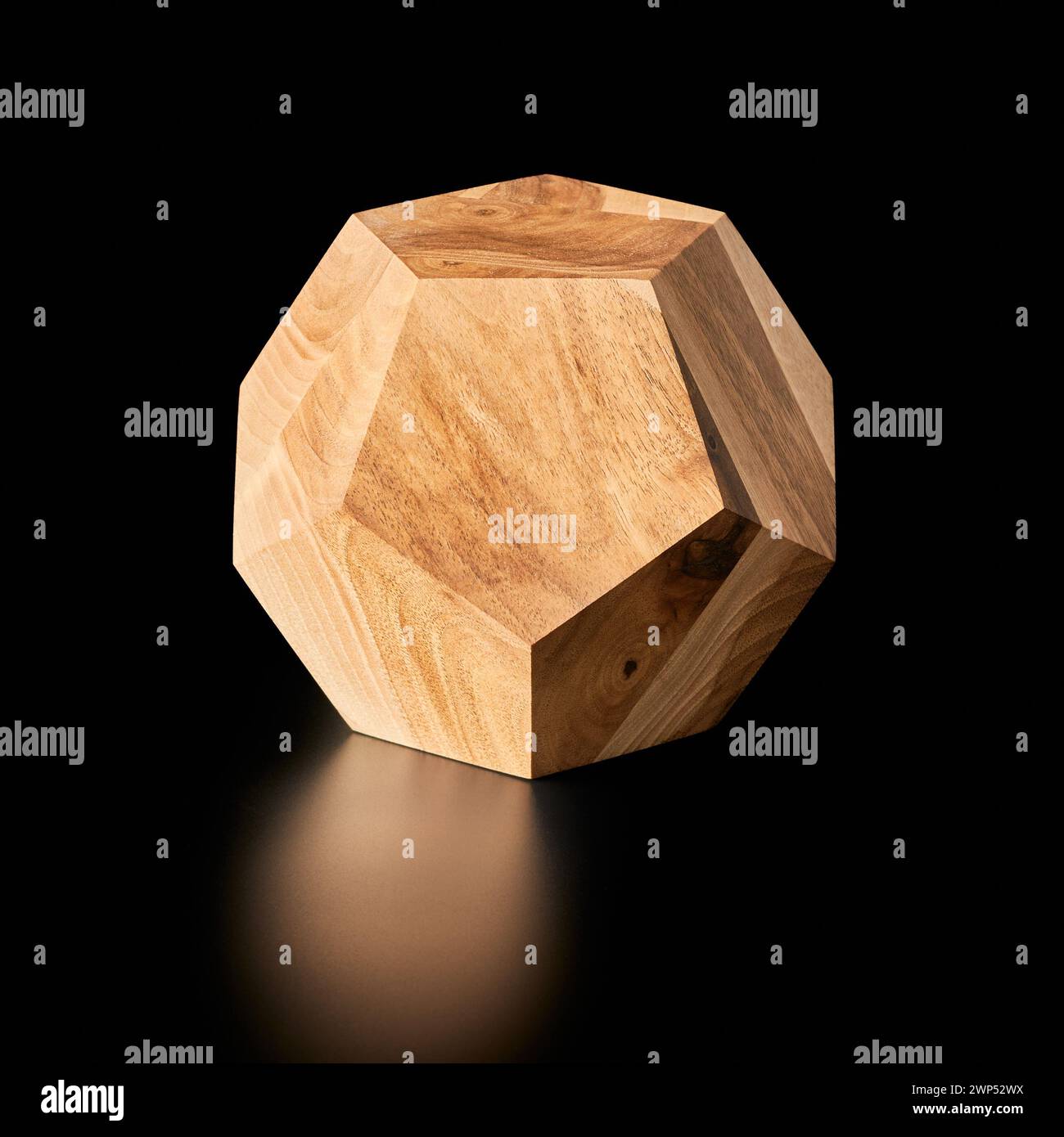 Handmade wooden regular dodecahedron - Platonic solid on a black background Stock Photo