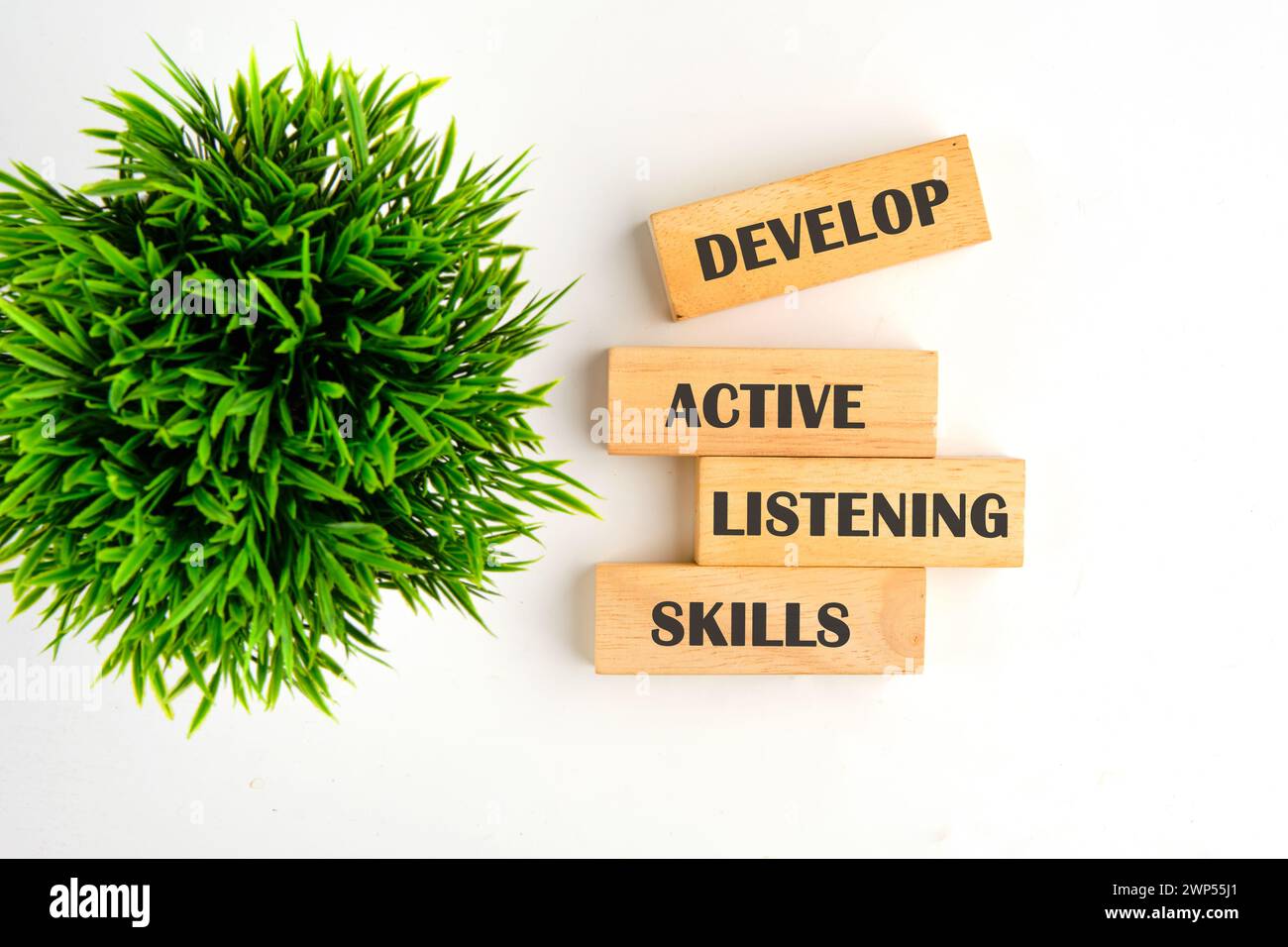 Concept word Develop active listening skills on wooden blocks on a ...