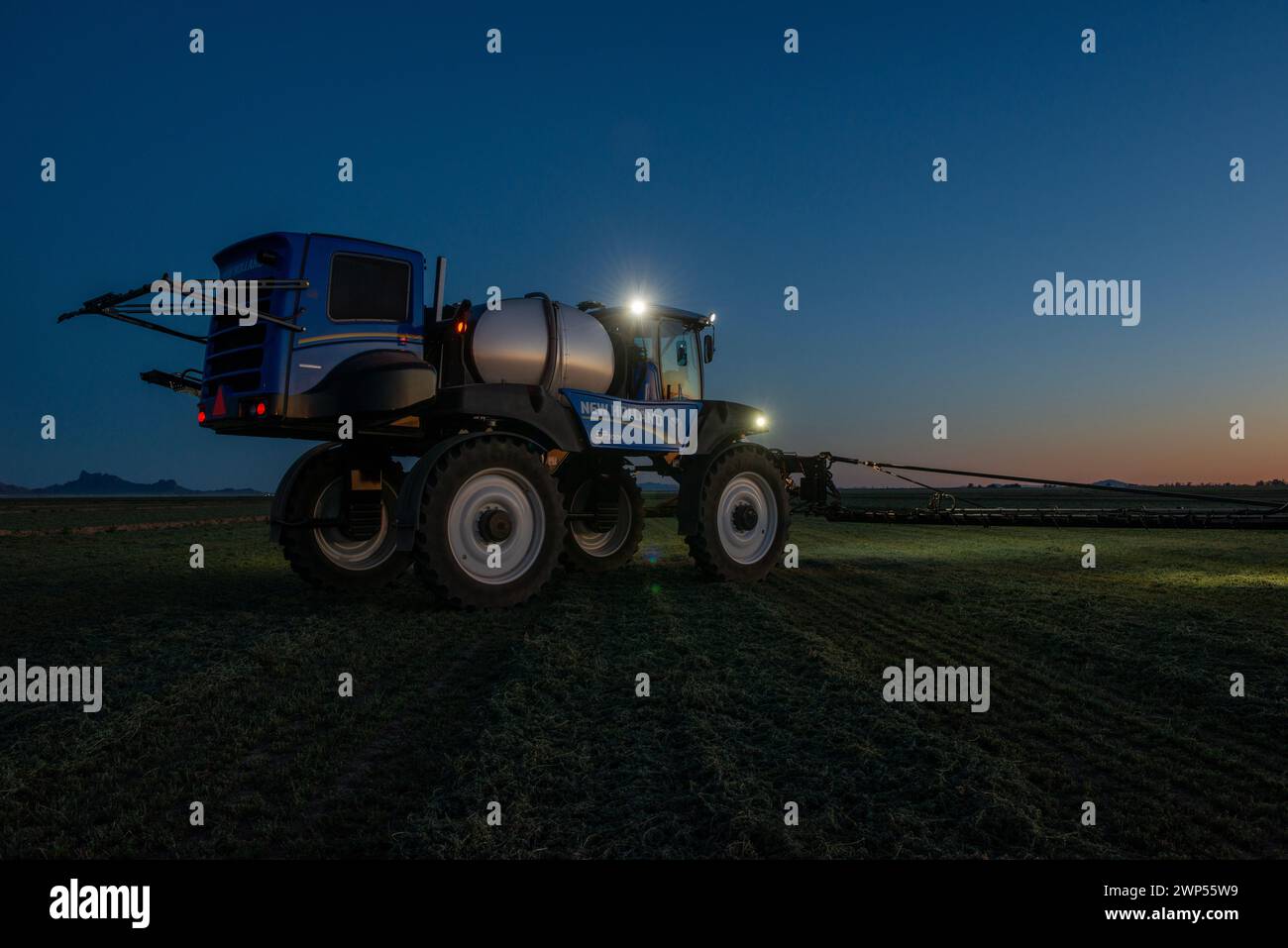 Agricultural Sprayer Machine at Sunset Stock Photo