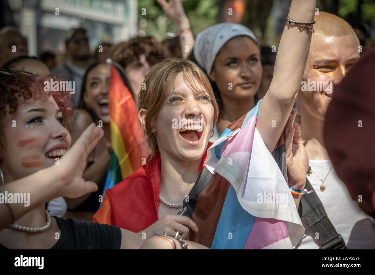 Paris, France - June 24, 2023: A woman looking at a float at the 2023 Paris gay pride surrounded by a crowd Stock Photo