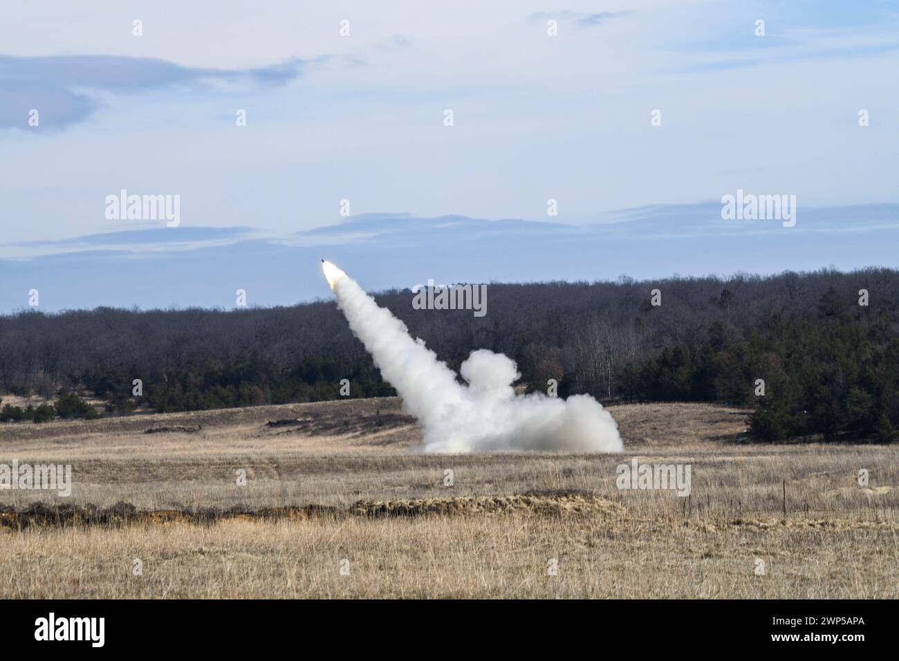 U.S. Soldiers of Bravo Battery, 1st Battalion, 182nd Field Artillery Regiment, Michigan Army National Guard, fire the M142 High Mobility Artillery Rocket System (HIMARS) during a winter live-fire exercise on Camp Grayling Michigan, March 2, 2024. Members of the unit conducted a Table VI qualification for section chiefs. (U.S. Army National Guard photo by Daniel Garas) Stock Photo