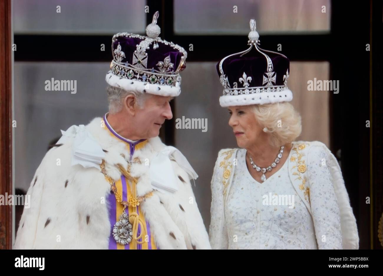 King Charles III and Queen Camilla wearing their crowns and ceremonial