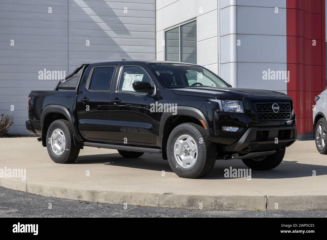 Fishers - February 3, 2024: Nissan Frontier SV Crew Cab display. Nissan offers the Frontier in S, SV, PRO-X, PRO-4X, and Midnight Edition. MY:2024 Stock Photo