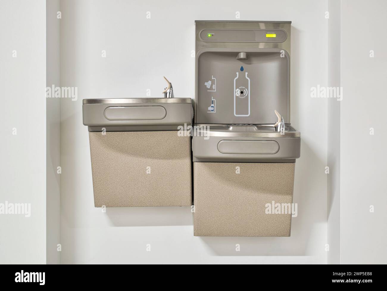 Water bottle refilling station with twin drinking fountains isolated by