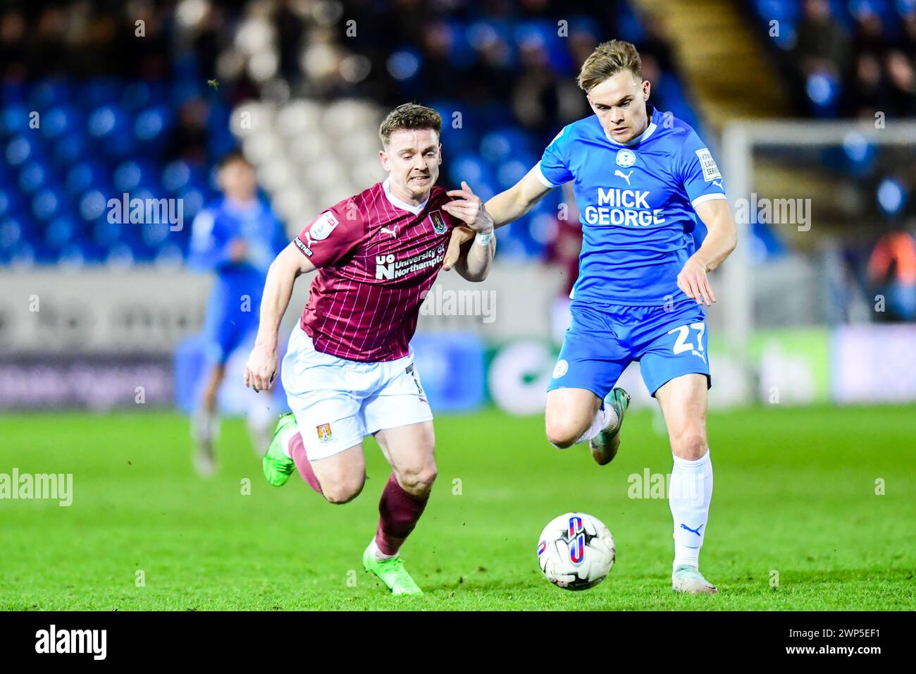 Archie Collins (27 Peterborough United) holds off Sam Haskins (7 Northampton Town) during the Sky Bet League 1 match between Peterborough and Northampton Town at London Road, Peterborough on Tuesday 5th March 2024. (Photo: Kevin Hodgson | MI News) Credit: MI News & Sport /Alamy Live News Stock Photo