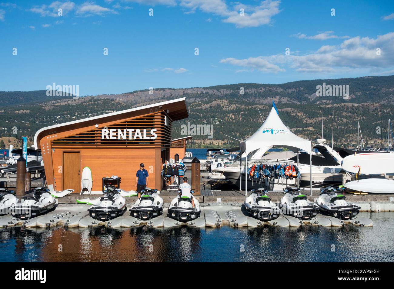 Workers prepare boats and personal powered water vessels for rental at
