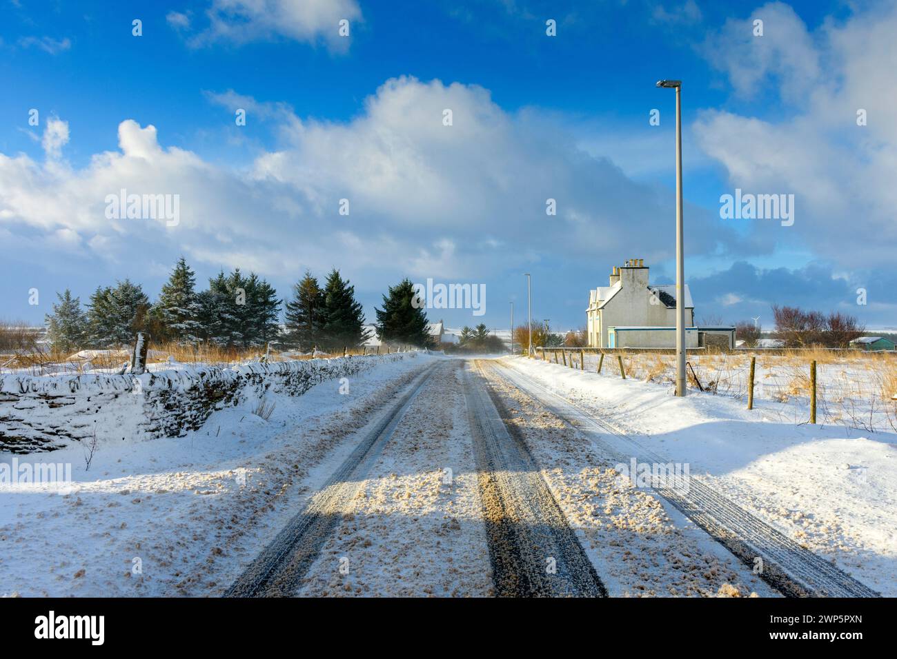 The A836 trunk road after a heavy snow fall, at the village of Mey, Caithness, Scotland, UK Stock Photo