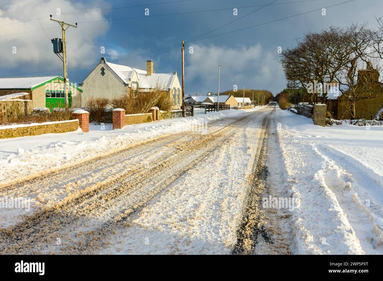 The A836 trunk road after a heavy snow fall, at the village of Mey, Caithness, Scotland, UK Stock Photo