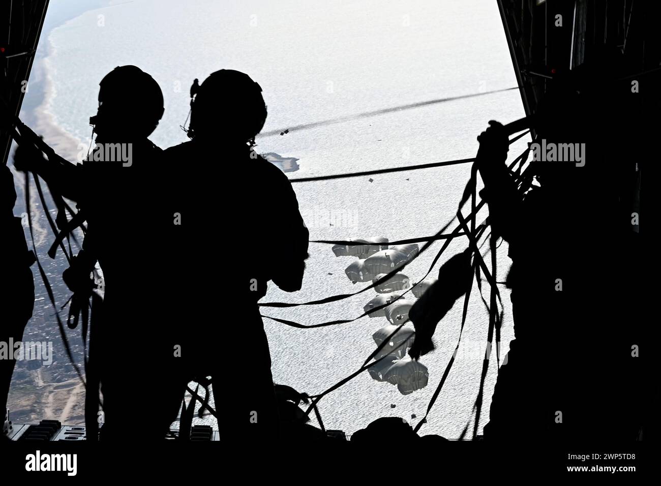 A U.S. Air Force loadmaster stands on the ramp of a HC-130J Combat King II after airdropping humanitarian aid over Gaza, on Tuesday, March 5, 2024. Three U.S. Air Force C-130 variants released 60 pallets, consisting of over 36,800 U.S. and Jordanian meals, during the humanitarian airdrop mission. The joint and combined mission leveraged the expertise of U.S. Air Force Central Airmen and U.S. Army Central Command Soldiers specializing in the packaging, loading, and release of pallets for aerial delivery. Photo via U.S. Air Force Courtesy/UPI Stock Photo