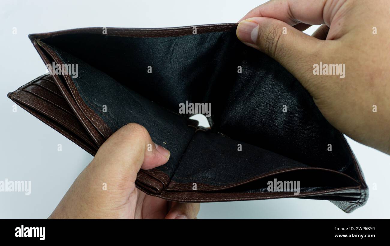 Empty wallet opened by hand isolated on white background Stock Photo