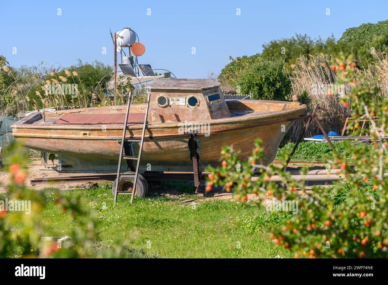 old fishing boat in front of a village house 1 Stock Photo - Alamy