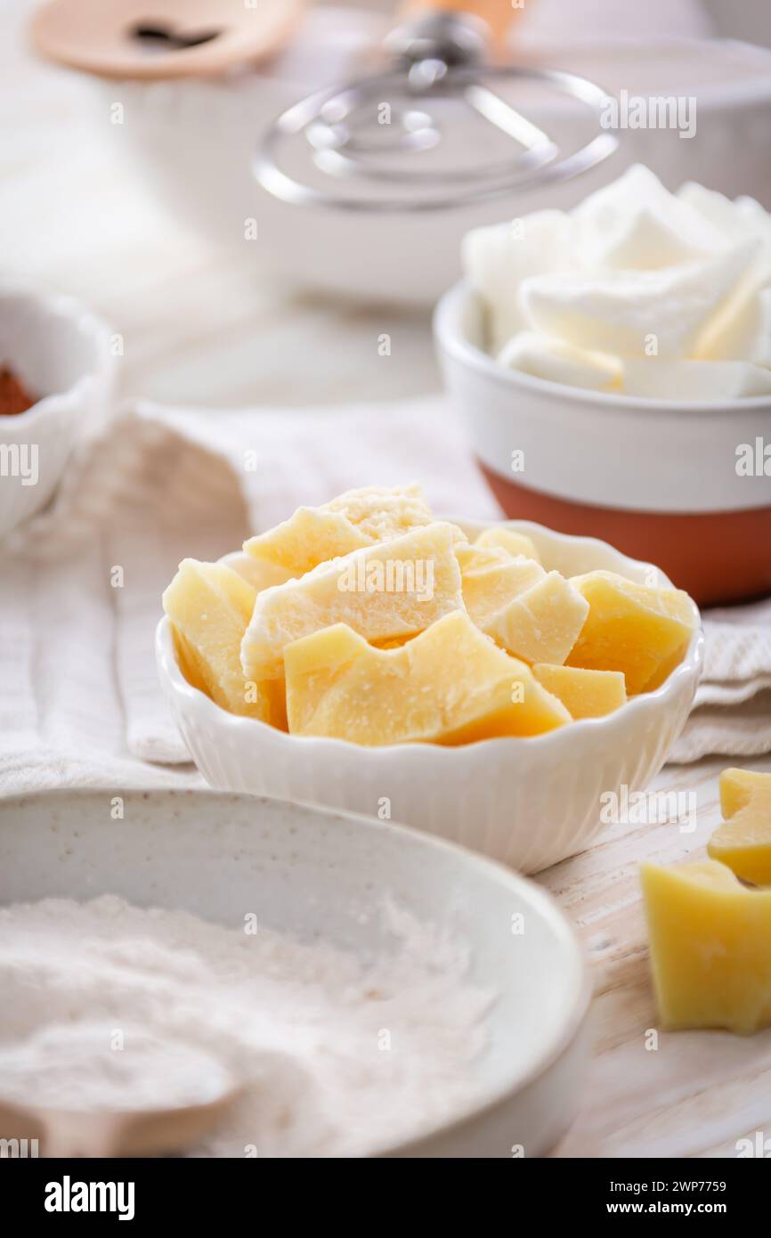 Organic cacao butter and baking ingredients with kitchen utensils Stock Photo