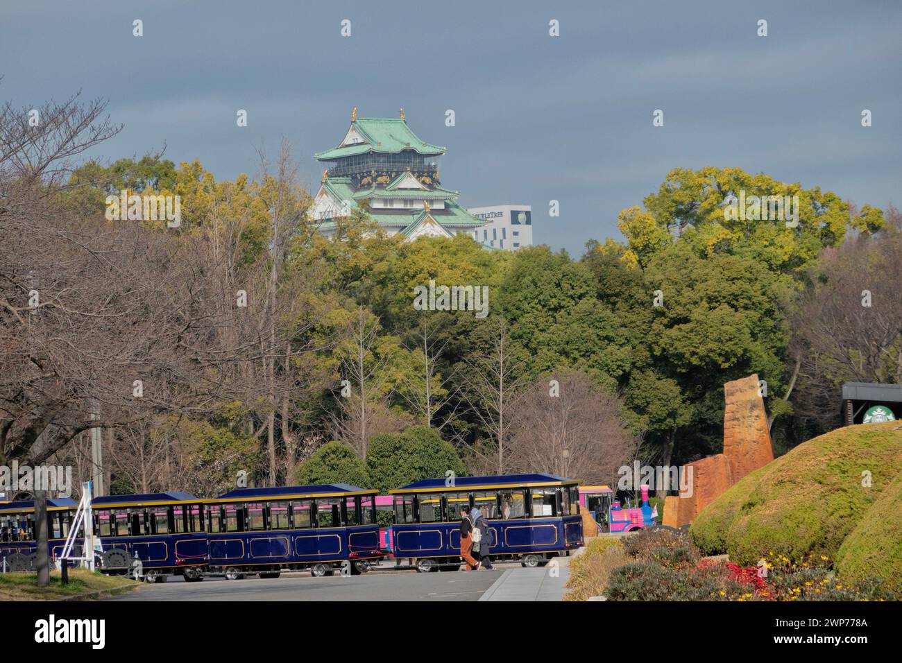 Osaka Castle rises above Osaka Castle Park, Osaka,  Japan Stock Photo