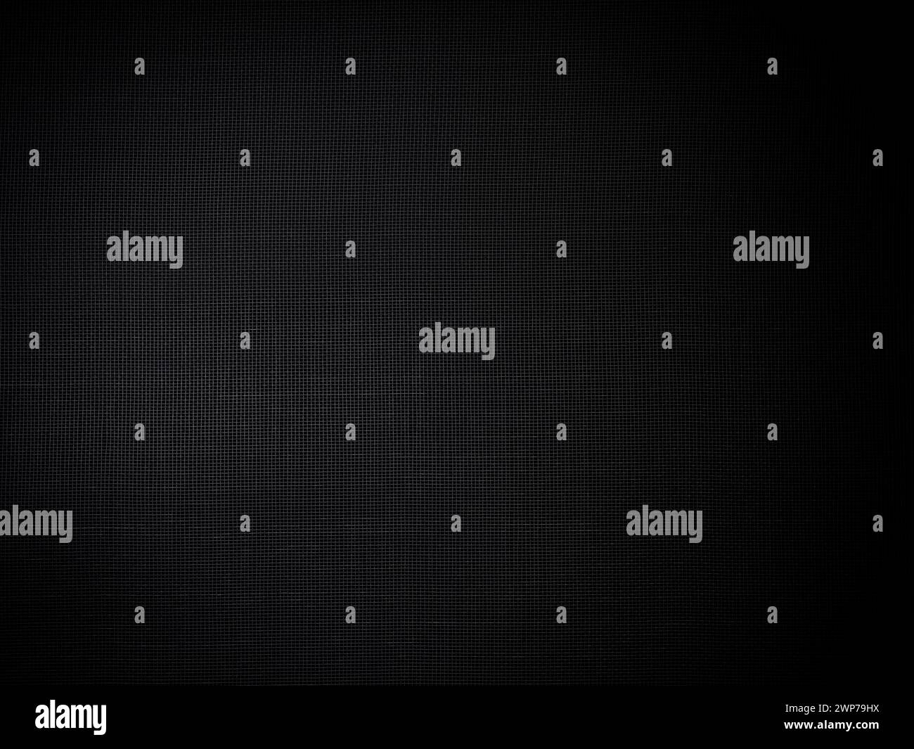 Black mesh metal fence structure. Black photo background. Dark colored