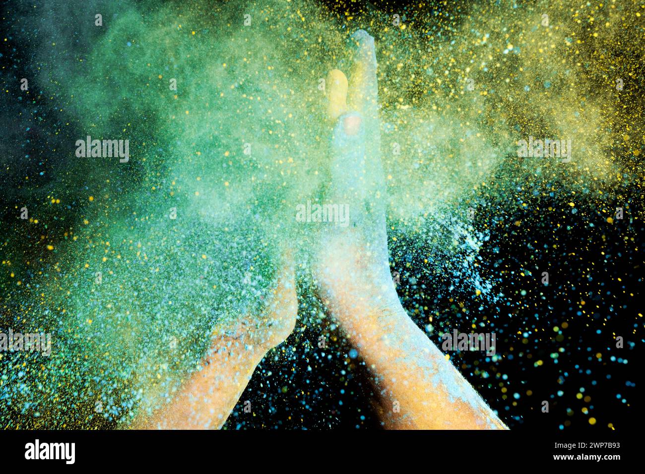 Human hand with colorful Holi powder on a black background. Holi ...