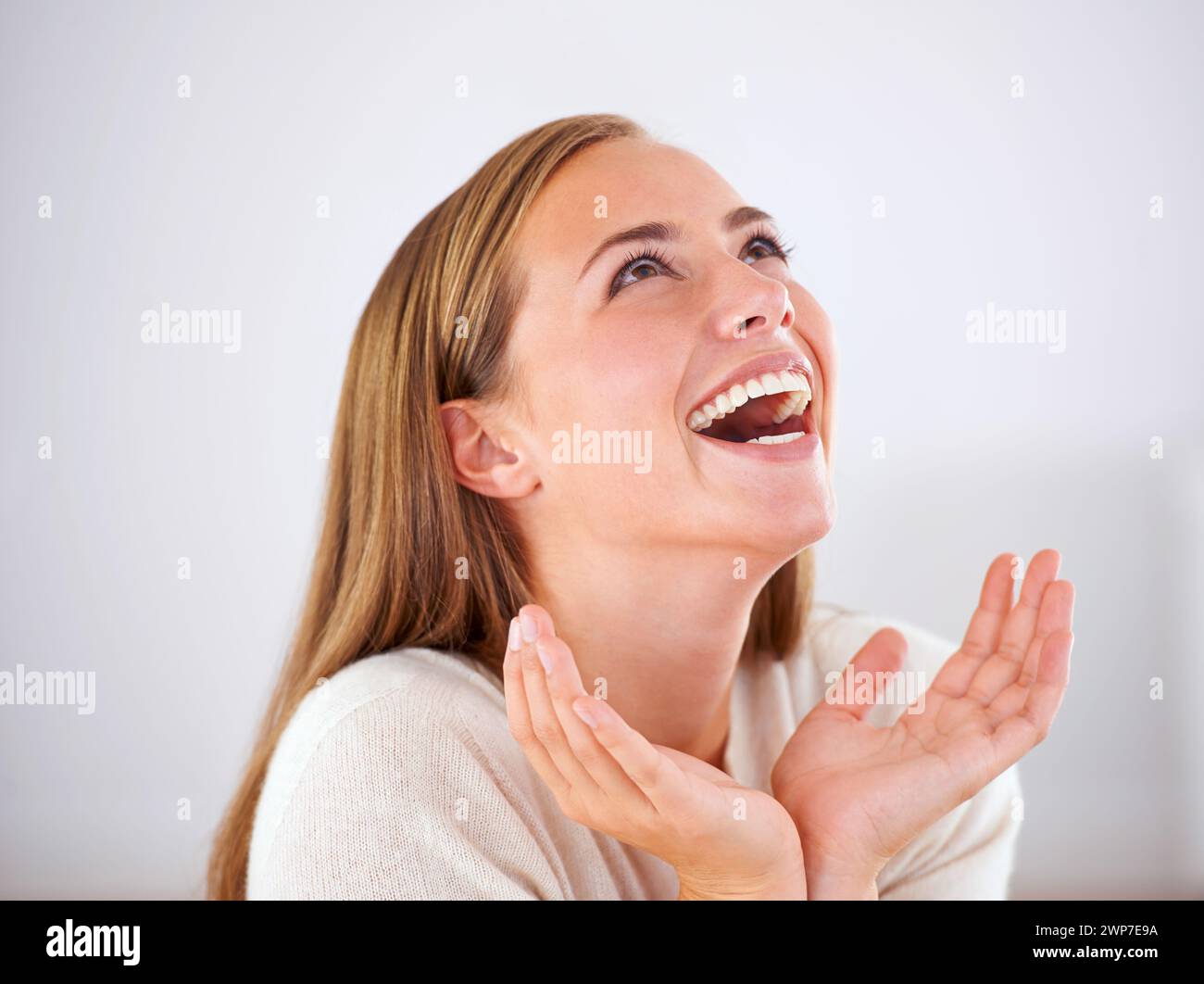 Laughing, woman and happiness in studio with funny, comedy or reaction to humor in white background. Crazy, joke and girl giggle with joy from Stock Photo