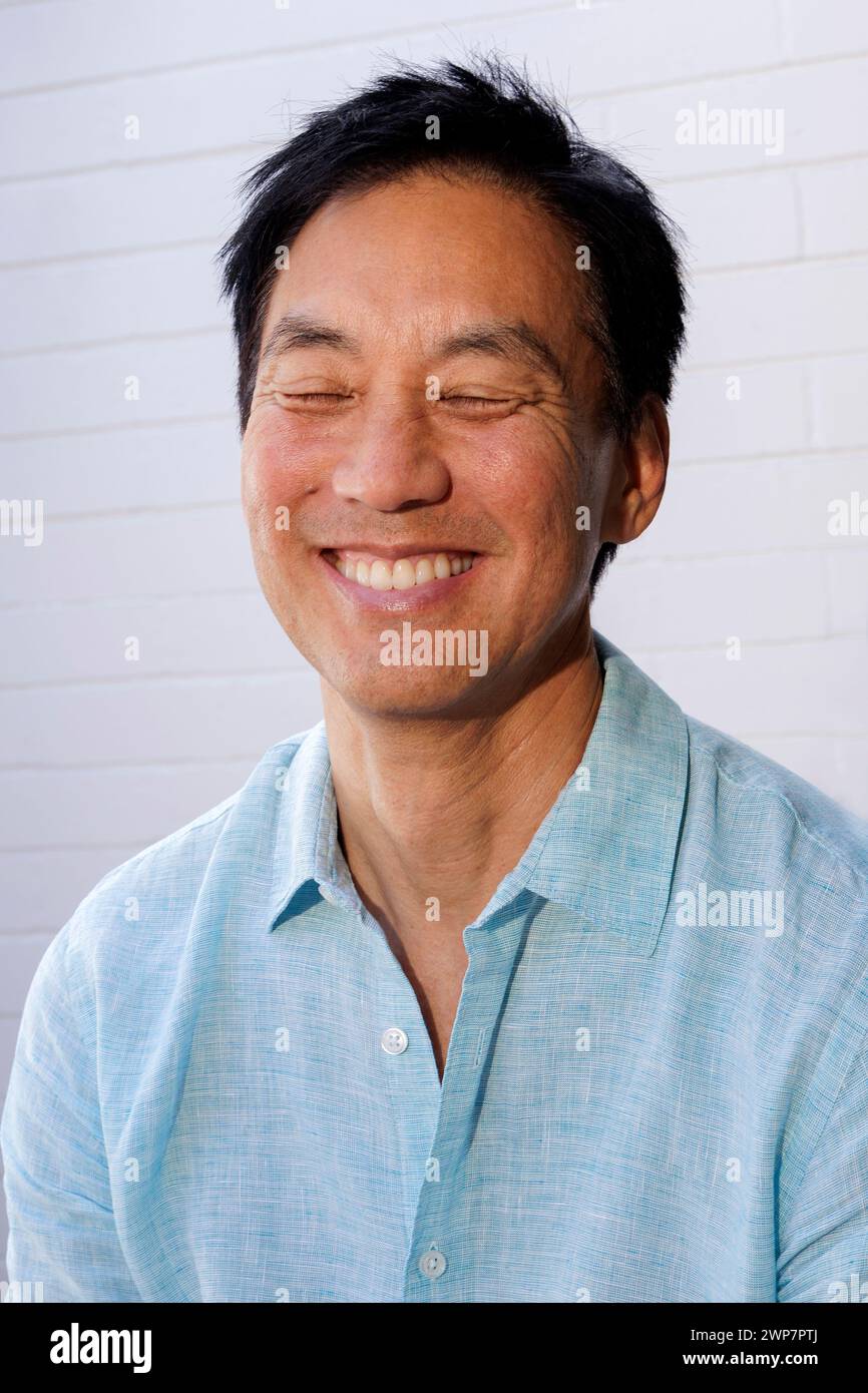 Portrait of laughing Asian man Stock Photo - Alamy