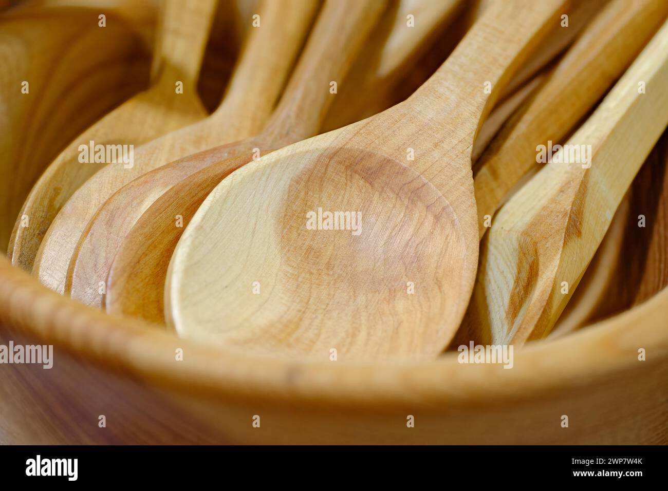 Group of handmade wooden spoons, close-up shot, abstract kitchenware background Stock Photo