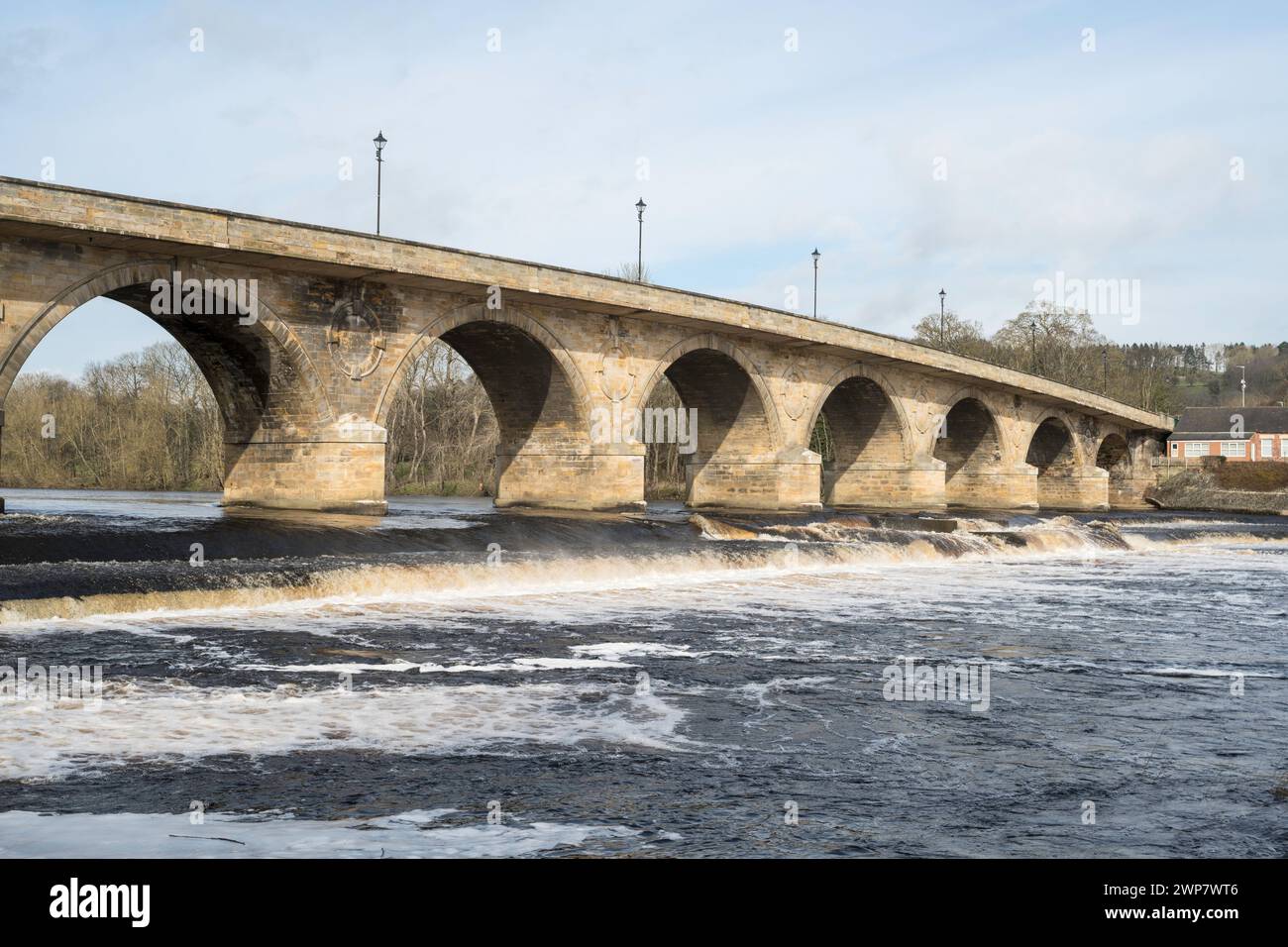 The late 18th century Hexham Bridge over the river Tyne, with the weir in the foreground, Northumberland, England, UK Stock Photo