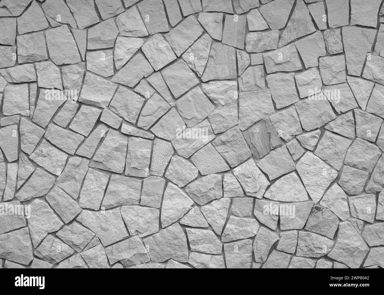 A wall made of pieces of decorative stone in black and white Stock