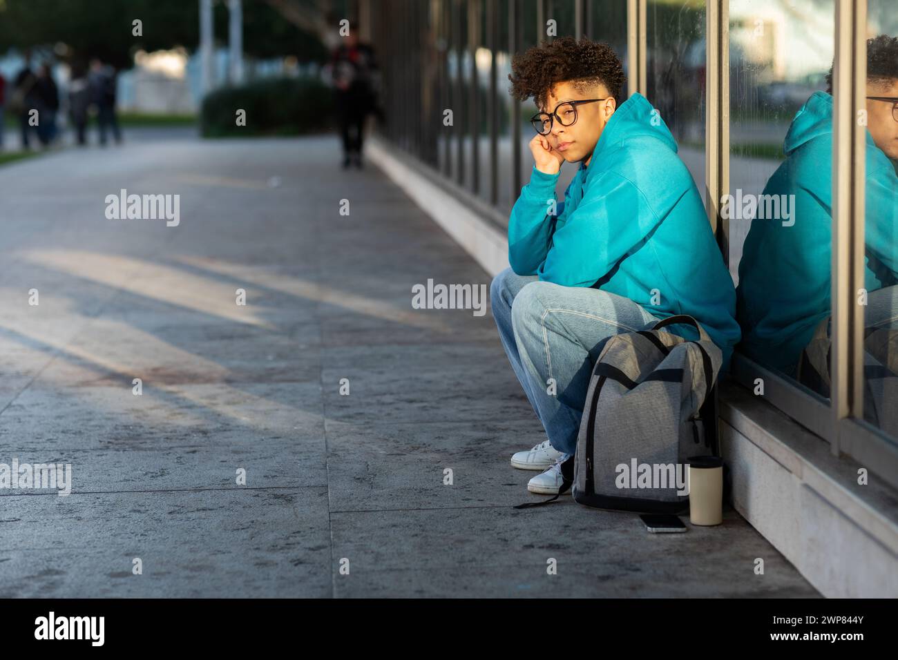 Unhappy black student guy sitting with backpack outdoors at night Stock ...