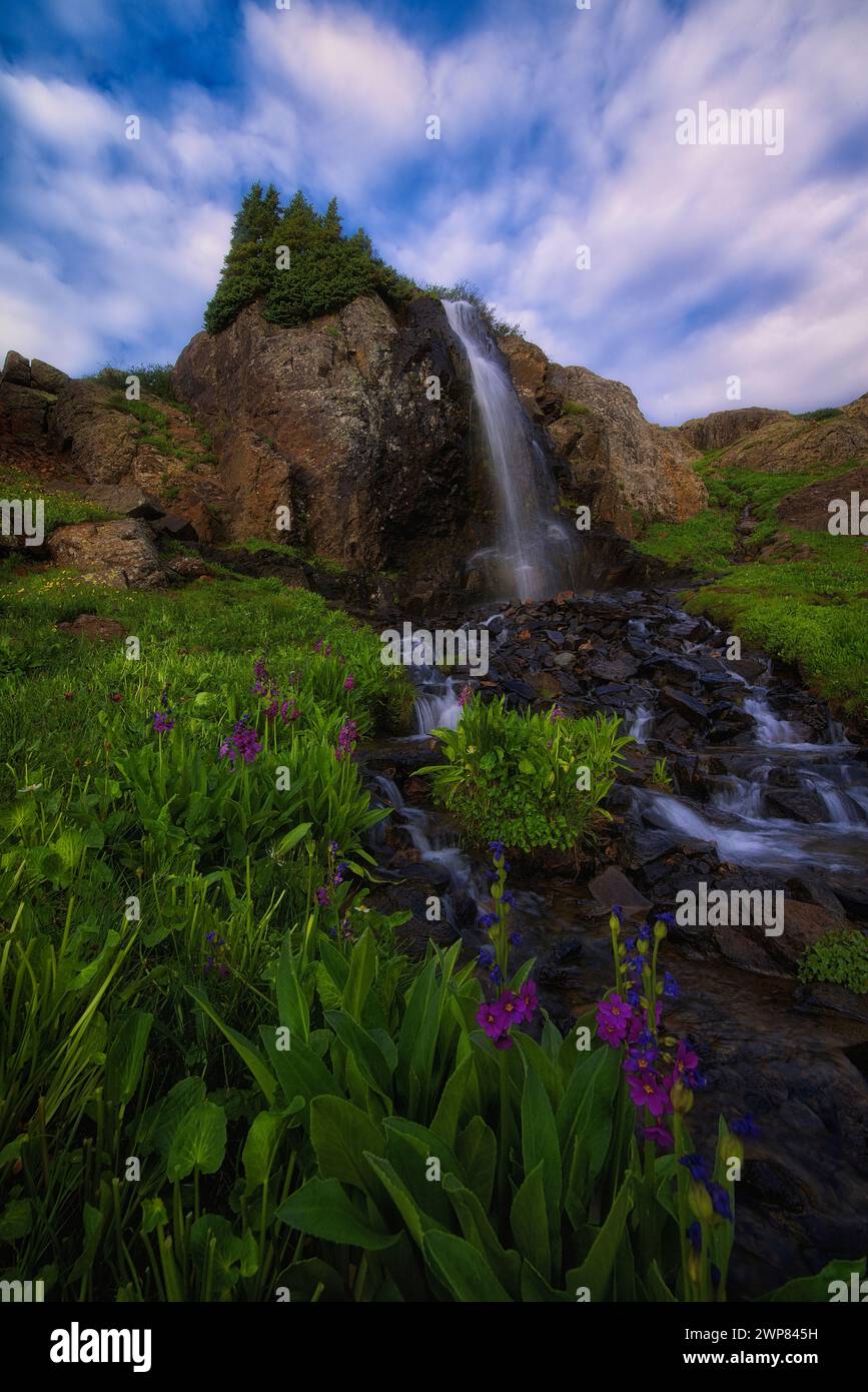 A Waterfall cascades down rocky mountainside Stock Photo - Alamy