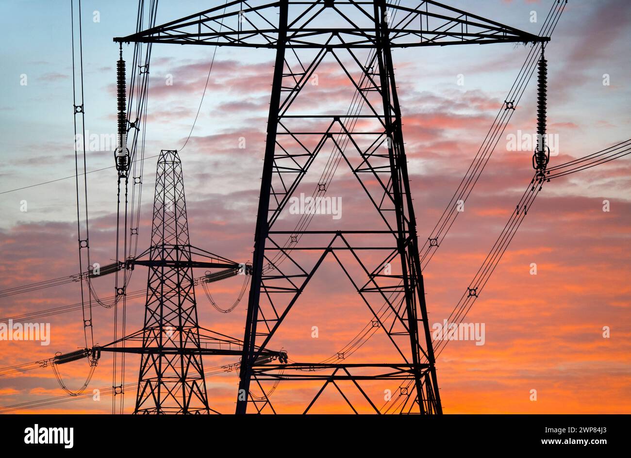 I have always been fascinated by our UK pylons - what in much of the world would be called transmission towers. Marching across the landscape, they ha Stock Photo