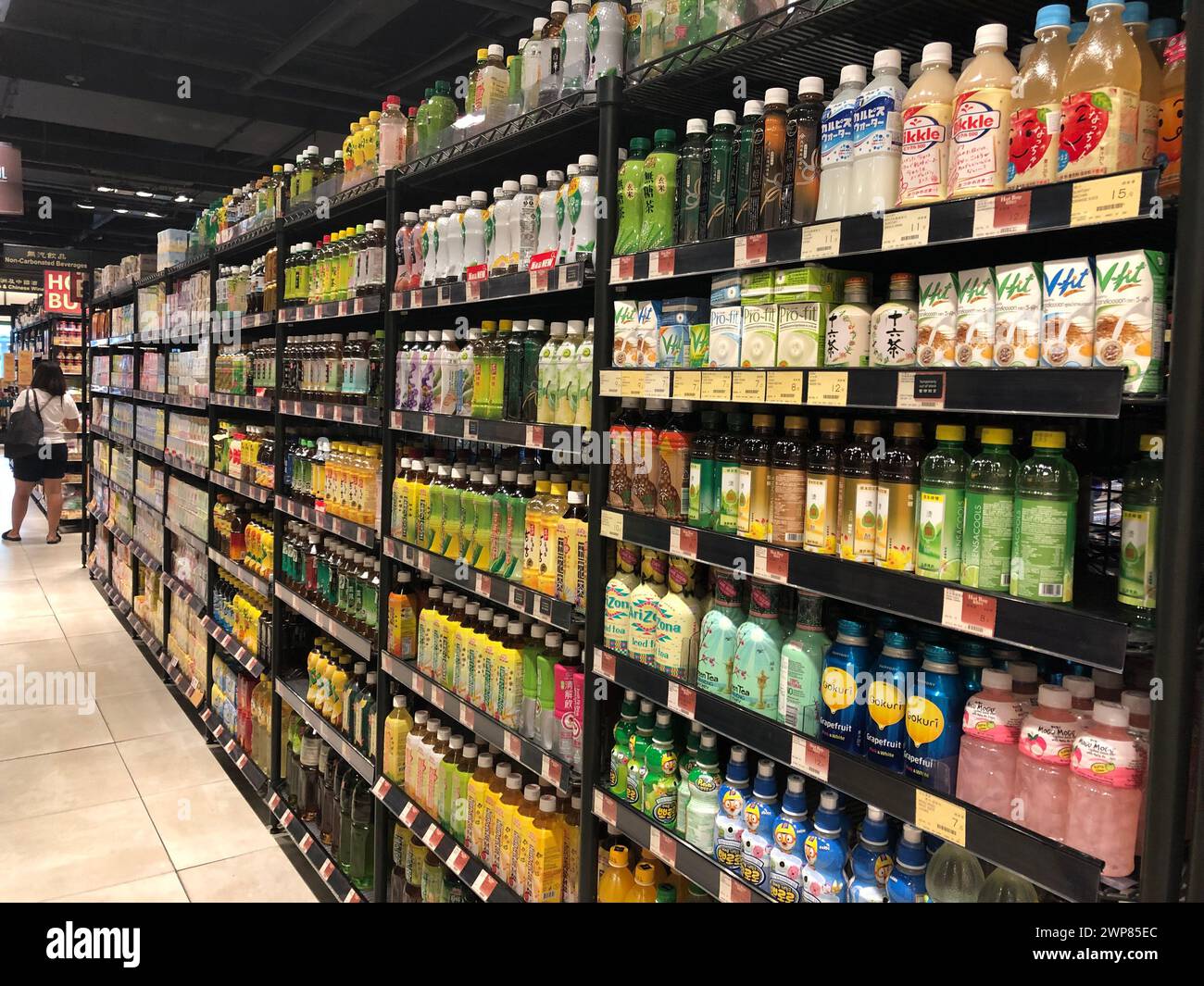 The shelves filled with assorted beverage flavors in a supermarket aisle in Hong Kong Stock Photo