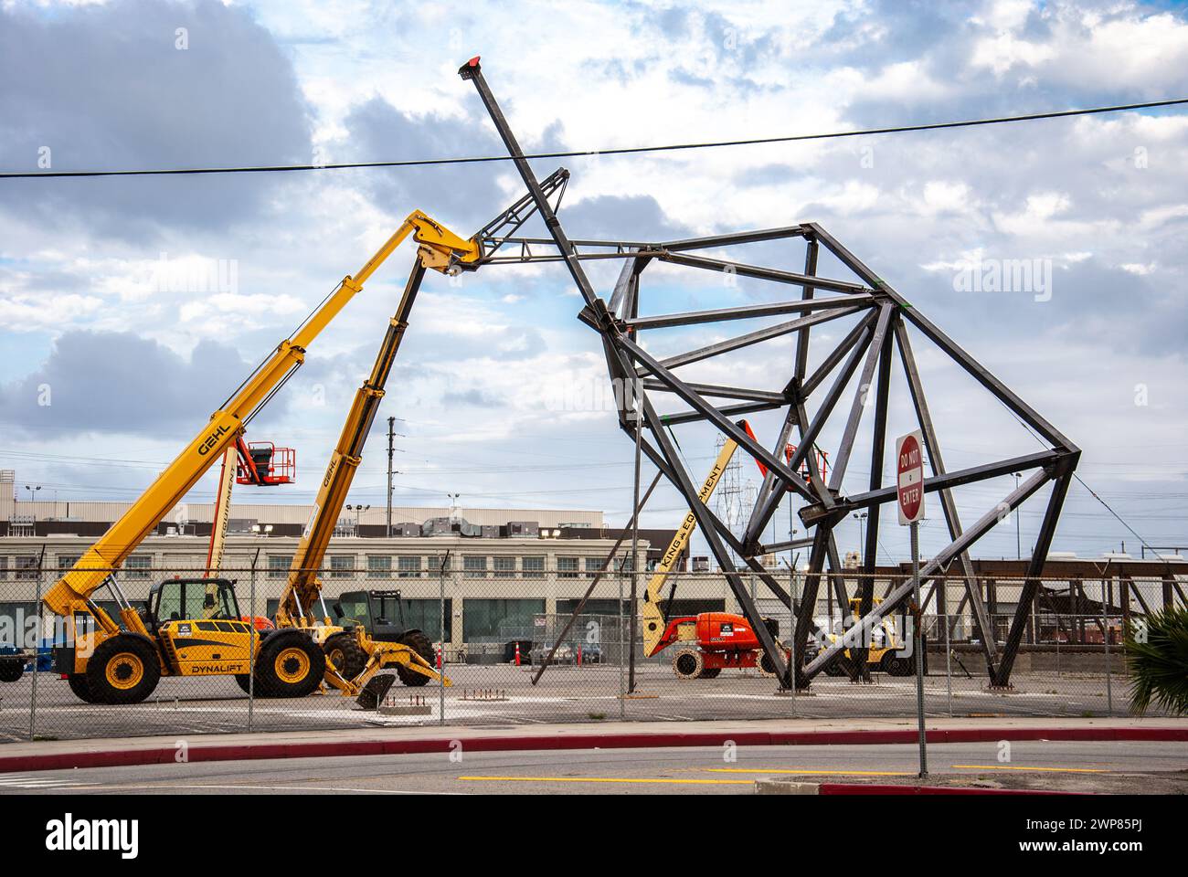 A crane connected to a modern art sculpture at Art district of Los Angeles Stock Photo