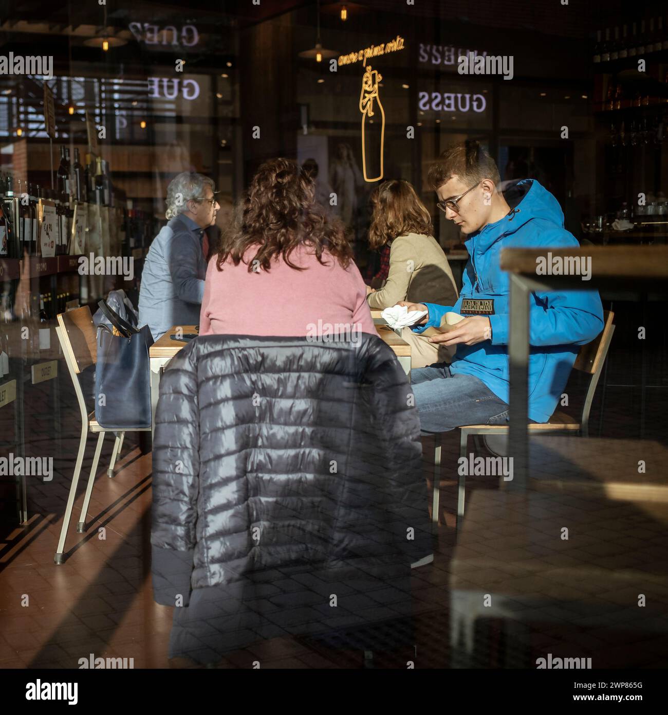 Novara, Italy, Jan 16, 2024: Guests in wine bar at “Vicolungo the Style Outlets” Stock Photo