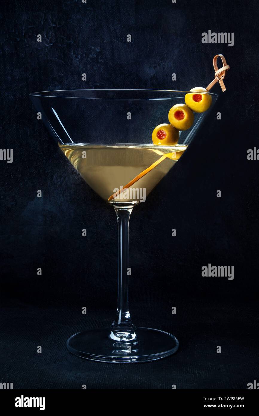 Martini. A glass of dirty martini cocktail with vermouth and olives, aperitif, on a dark background Stock Photo