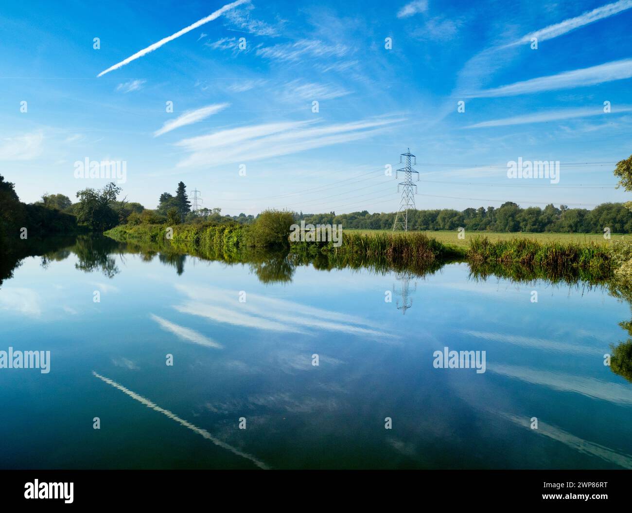 This beautiful and somewhat surreal scene of deep skies, vapour trails and reflections was filmed by the Thames at Kennington. It was first light on a Stock Photo
