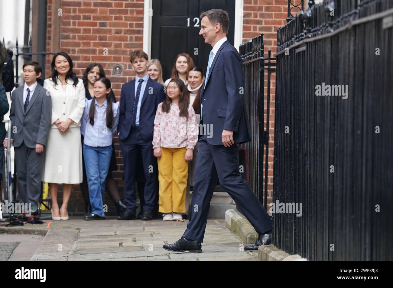 Jack Hunt (left), Lucia Hunt (second from left), Anna Hunt (fourth from left) and Eleanor Hunt (fourth from right) watch Chancellor of the Exchequer Jeremy Hunt outside 11 Downing Street, London, with his ministerial box before delivering his Budget in the Houses of Parliament. Picture date: Wednesday March 6, 2024. Stock Photo