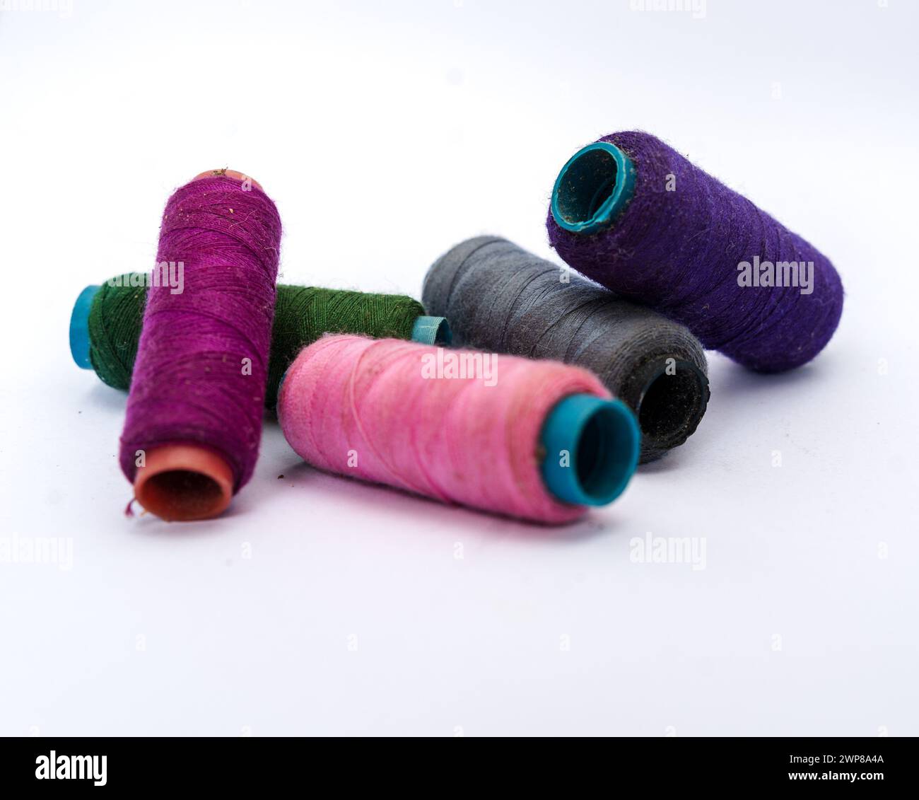 Pile of colorful sewing threads on isolated white background.Colored