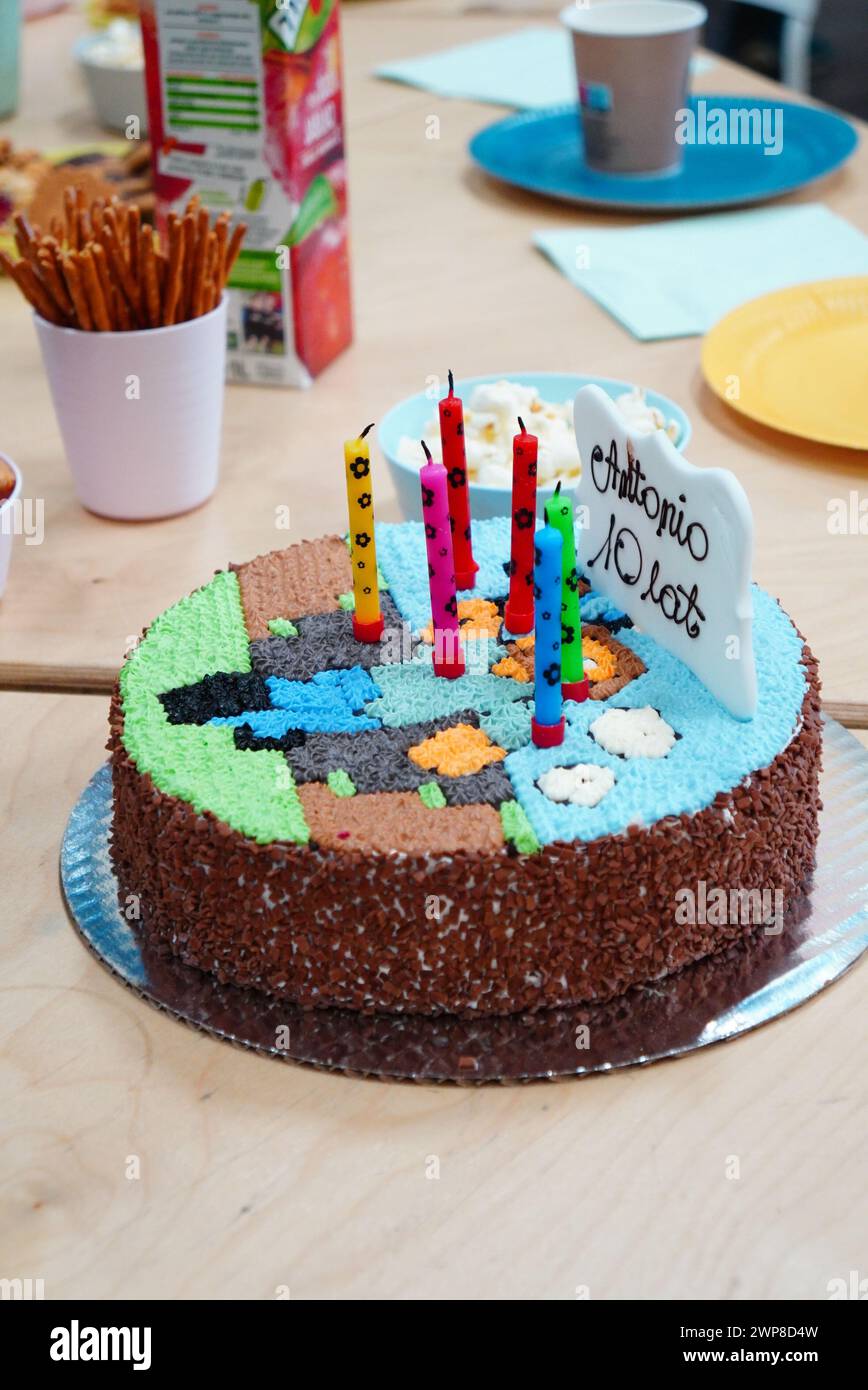A chocolate cake adorned with an assortment of candles Stock Photo
