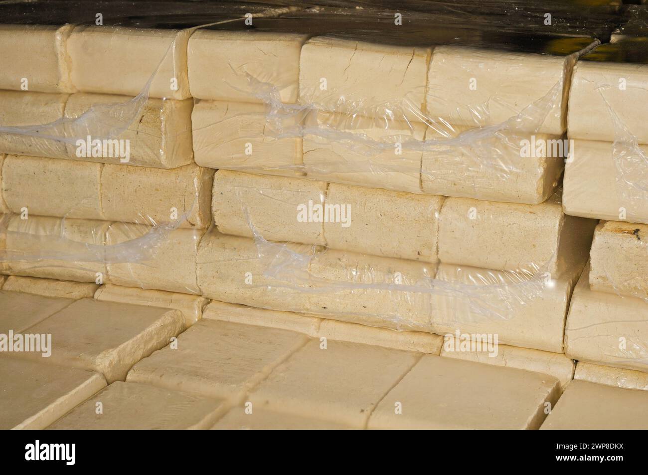A Stack of shrink-wrapped wood briquettes Stock Photo - Alamy