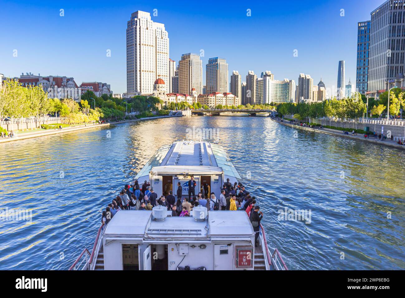 People enjoying a river cruise on the Hai river in Tianjin, China Stock Photo