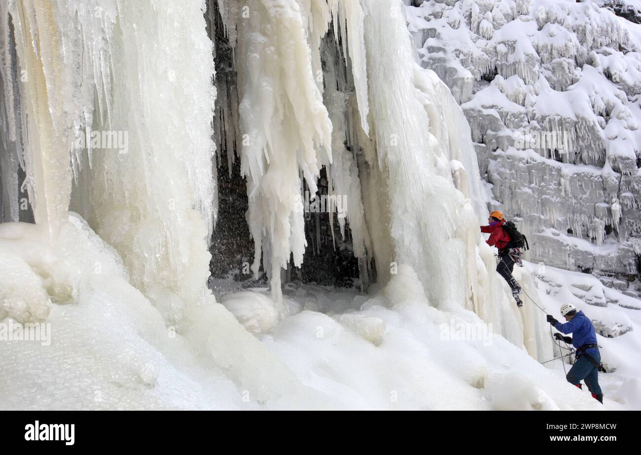 22/01/13  Mark Procter (orange helmet) and David Pendlebury were the first pair to make the climb today.  After many days below zero a giant waterfall Stock Photo