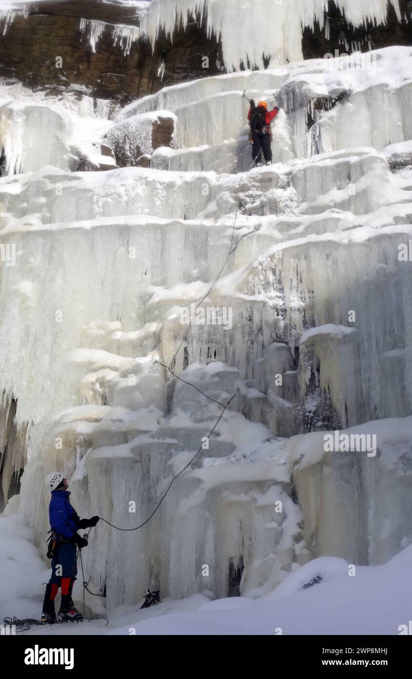 22/01/13  Mark Procter (orange helmet) and David Pendlebury were the first pair to make the climb today.  After many days below zero a giant waterfall Stock Photo