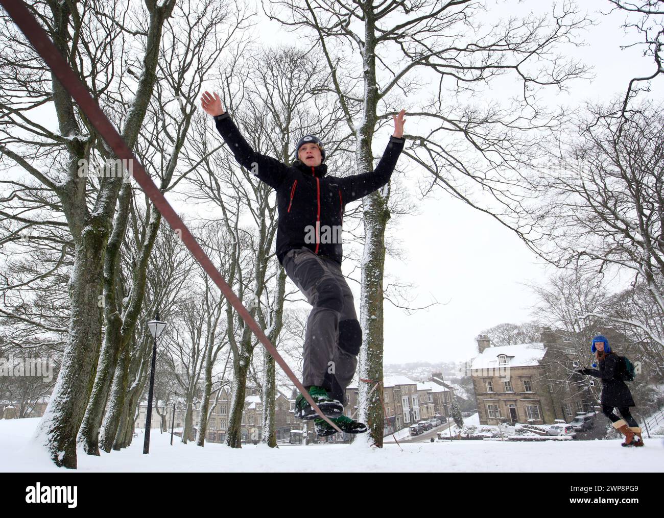 05/02/13   Matt Stevens, 19, practises slacklining across a line strung between trees in Buxton, Derbyshire during heavy snowfall. 'The snow gives a s Stock Photo