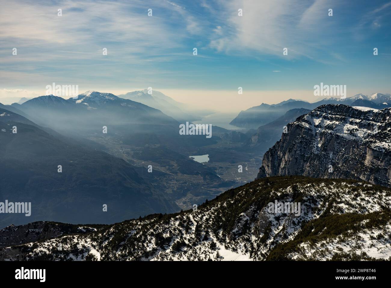 Snow covered Italian Dolomites at winter. Lake garda view in  Trentino-Alto Adige, Italy. Ski slopes and snow holidays in Andalo in the Italian Dolomi Stock Photo